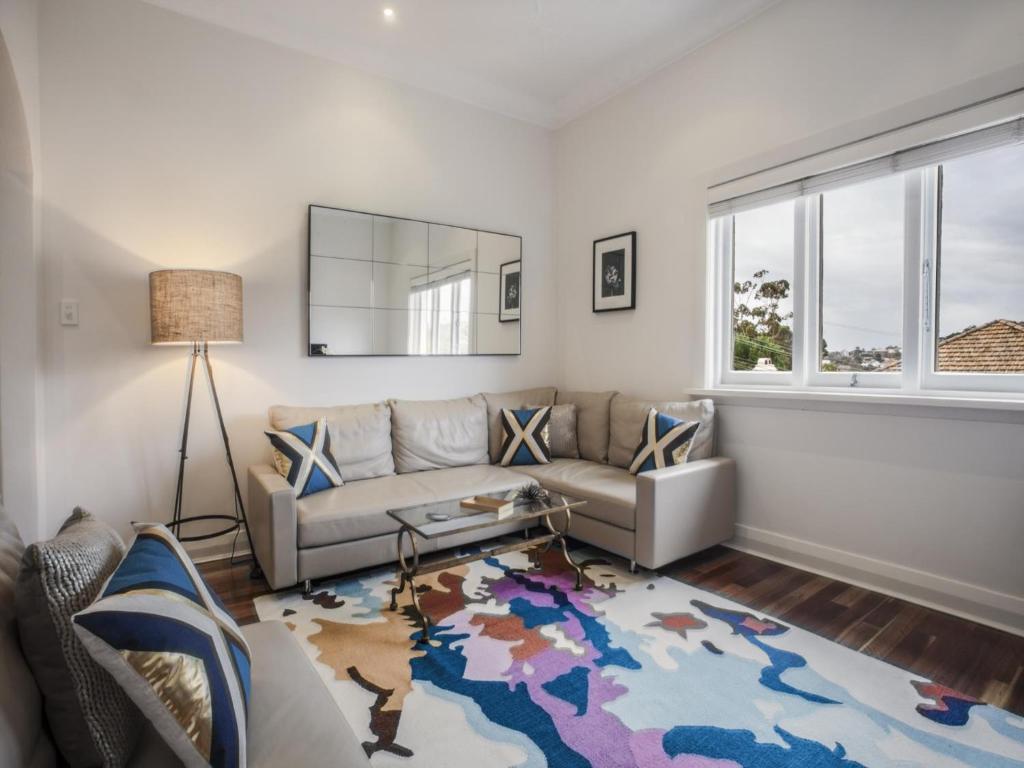 悉尼胡拉勒罗斯林达勒大道公寓的带沙发和地图地毯的客厅