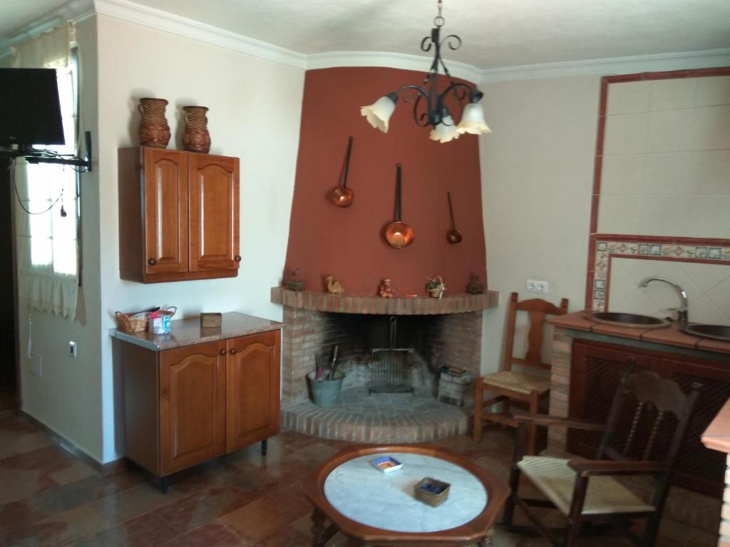 普拉多德尔雷查孔公寓的客厅设有壁炉和桌子