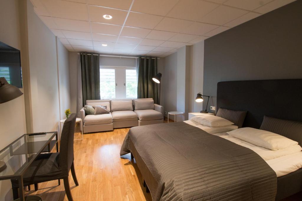 哥德堡斯波顿酒店的一间卧室配有一张床、一张桌子和一张沙发