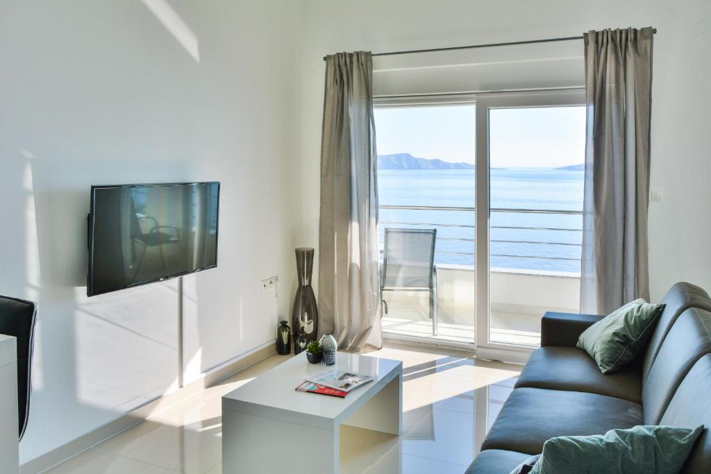 塞尼Apartments & Rooms Kata - Adults Only的带沙发和大窗户的客厅