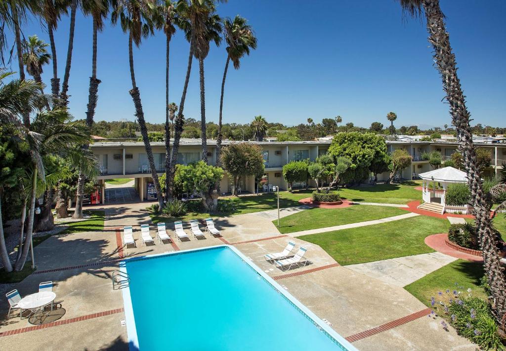 长滩Golden Sails Hotel的享有度假村的空中景致,设有游泳池和棕榈树