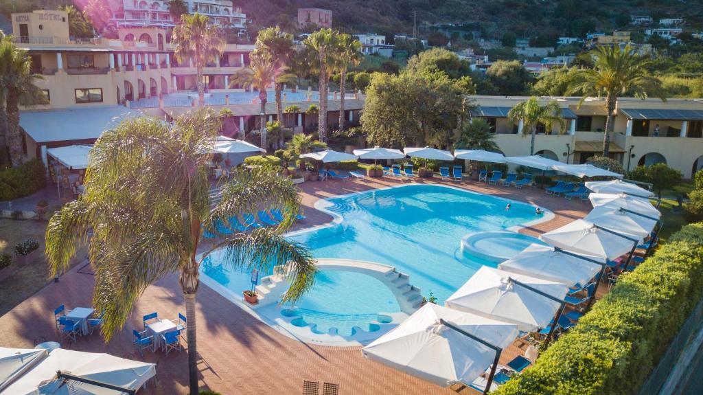 利帕里阿克缇亚酒店的享有带遮阳伞的度假村游泳池的空中景致