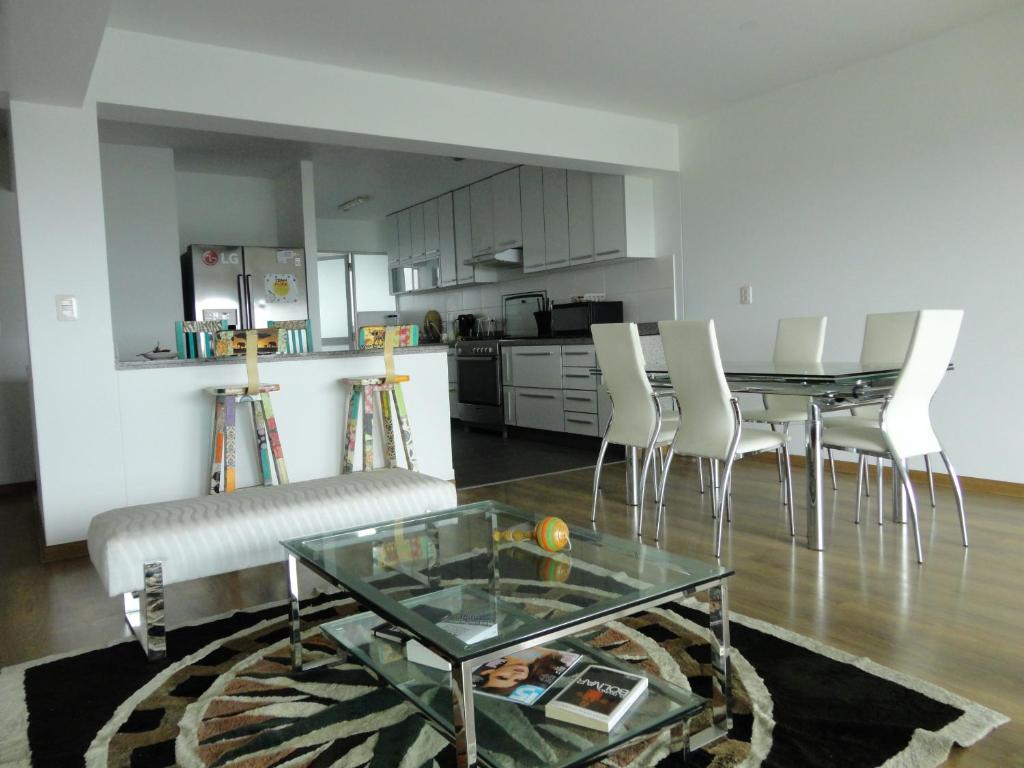 利马San Borja, bello apartamento的一间带桌椅的客厅和一间厨房
