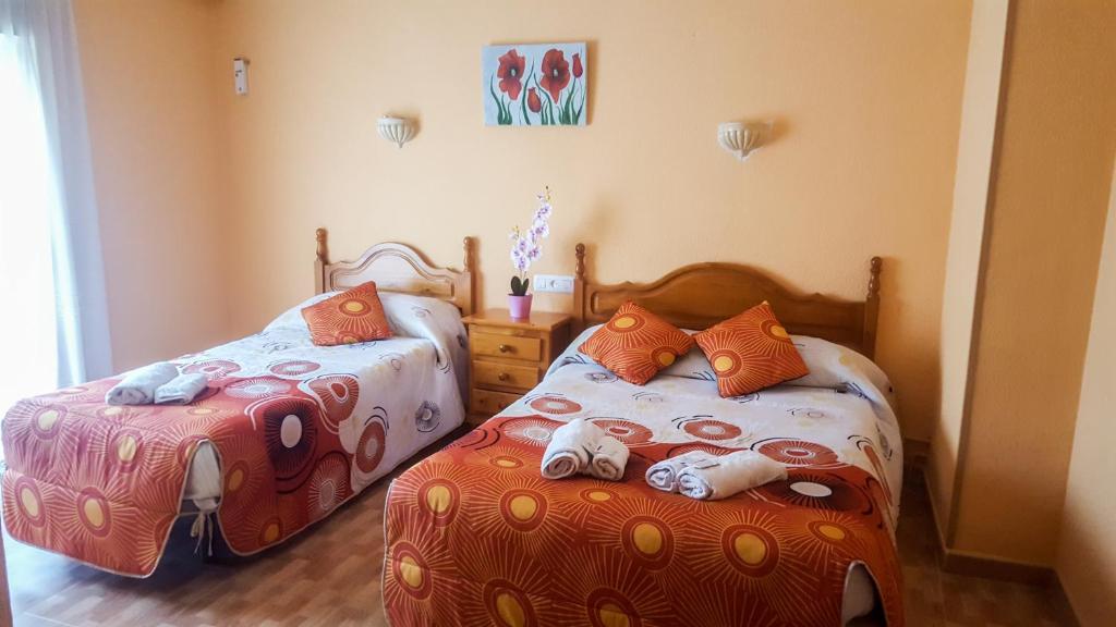 普瑞拉纳Hostal El Caminero的一间卧室设有两张床,里面饲养着动物。