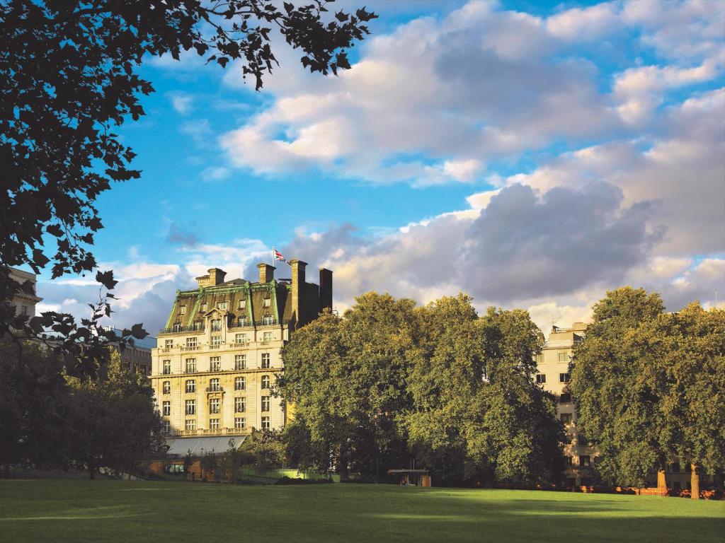 伦敦伦敦丽兹酒店的一座树木繁茂的公园中的白色大建筑