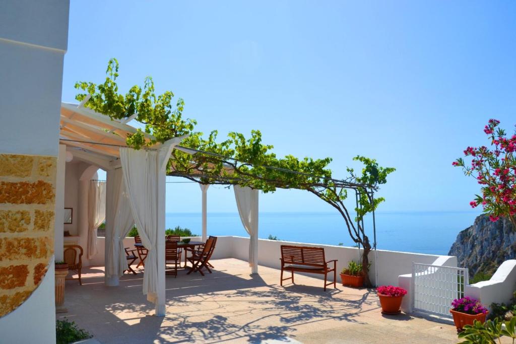 科尔萨诺villa Sonia的一个带桌椅的庭院和大海