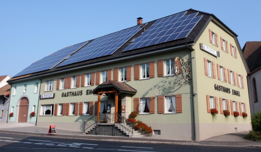 劳芬堡Hotel-Gasthaus Engel Luttingen的屋顶上设有太阳能电池板的建筑