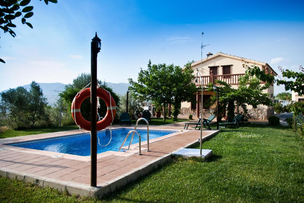 波索阿尔孔Casas Rurales Cazorla-Alcón的院子里的游泳池,有红环