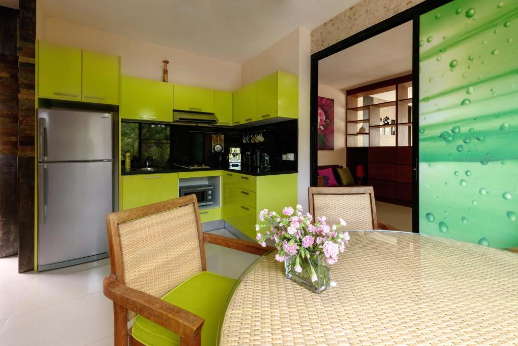 湄南海滩Condo AVANTA Deluxe A301的厨房配有一张桌子,上面放着花瓶