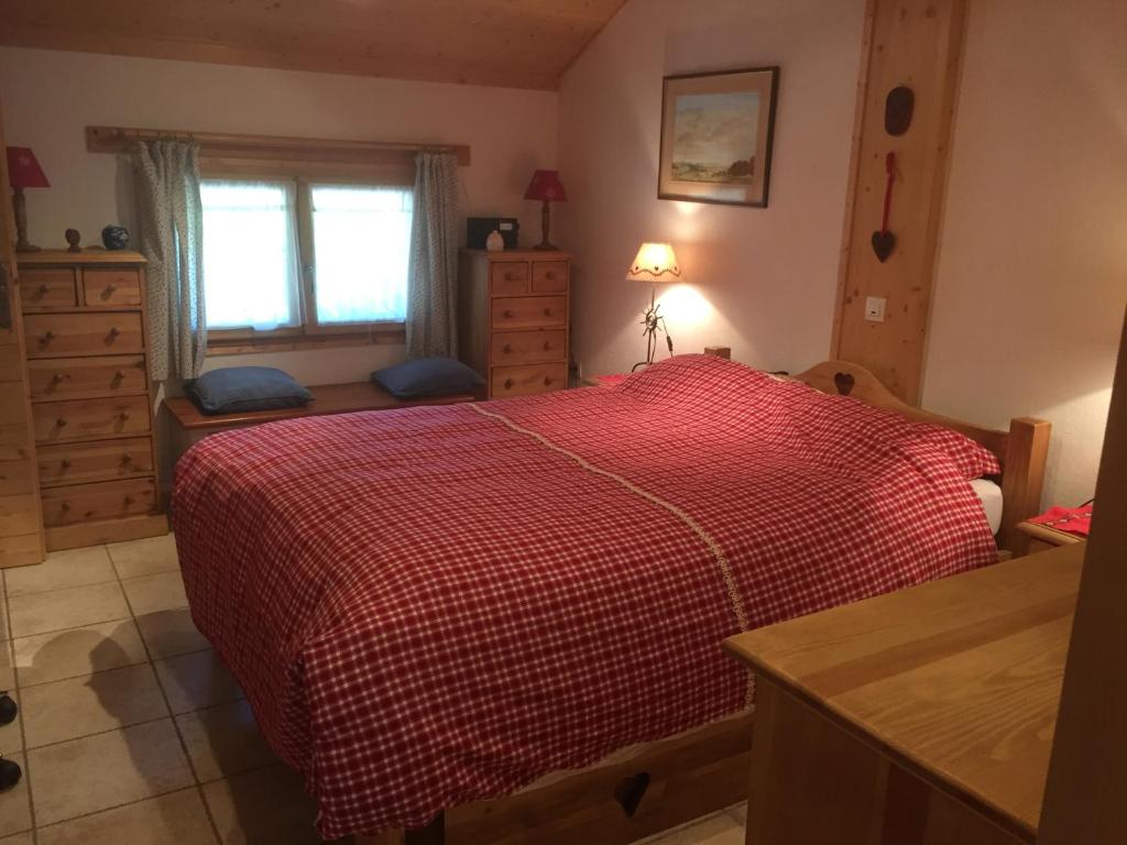 托讷猫头鹰小木屋的一间卧室设有红色的床和窗户。