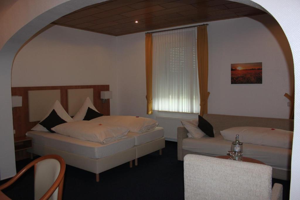 雷斯Gasthof Tepferdt的一间卧室设有两张床、一张沙发和一个窗口