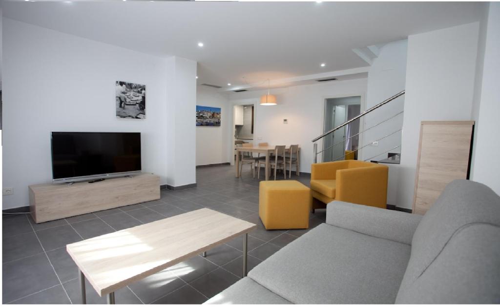 坎布里尔斯Apartamentos Ocea的带沙发和平面电视的客厅