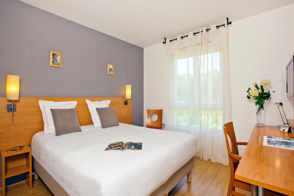 安锡塞祖尔阿菲尔安内西九桥酒店的卧室配有一张白色大床和一张书桌