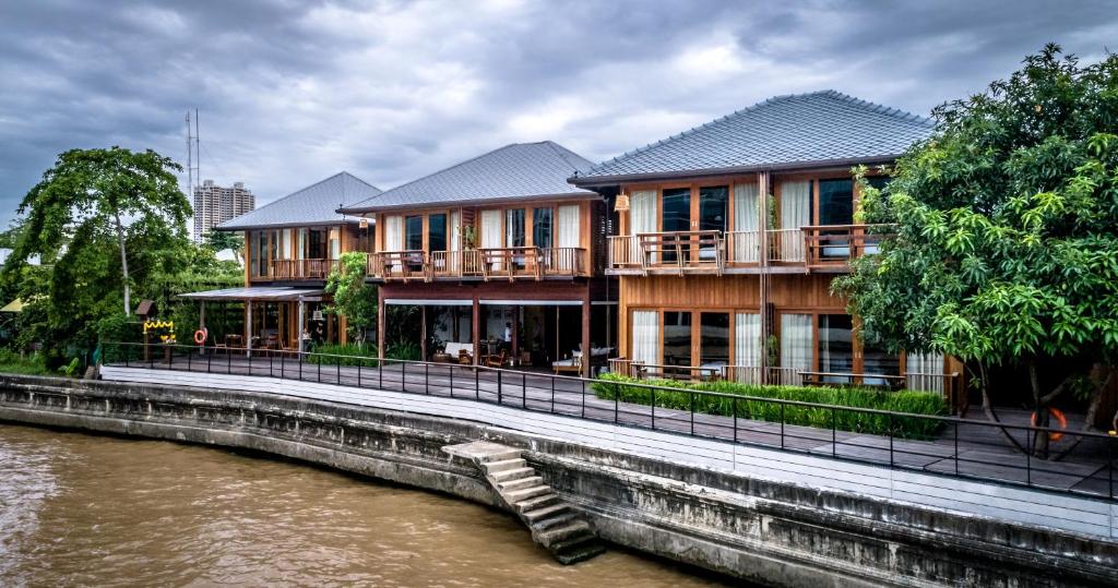 曼谷曼谷产内酒店的河边的建筑物,毗邻房子