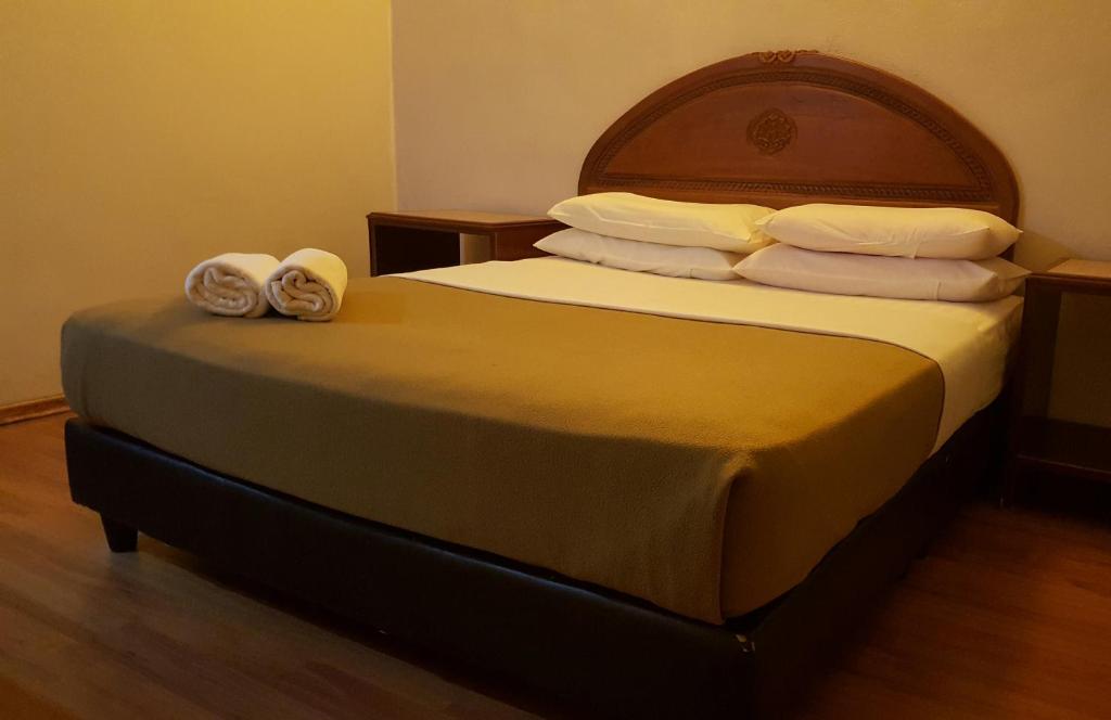 珍南海滩椰子兰卡威度假屋的一间卧室配有一张床,上面有两条毛巾