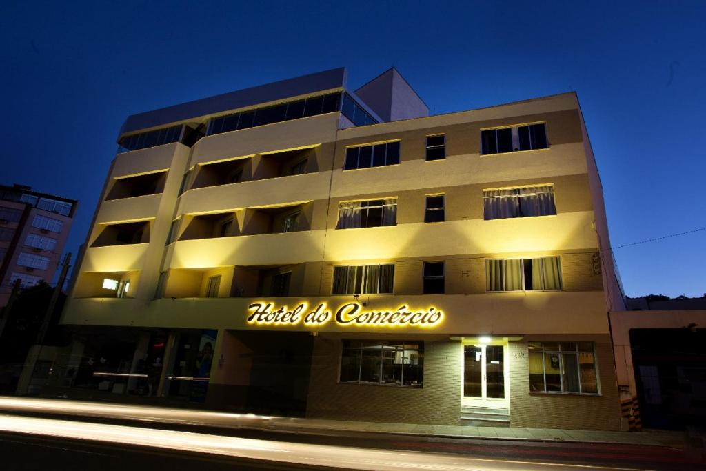 若阿萨巴Hotel do Comércio的带有标牌的建筑,上面写着酒店以中心为中心