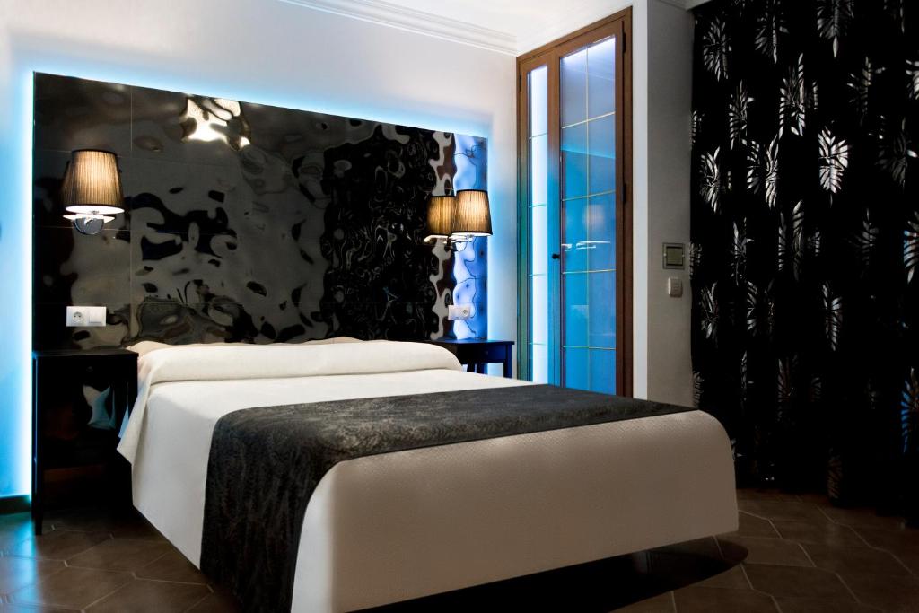 内尔哈阿罕布拉旅馆 - 仅限成人入住的一间卧室配有一张白色大床和黑色墙壁
