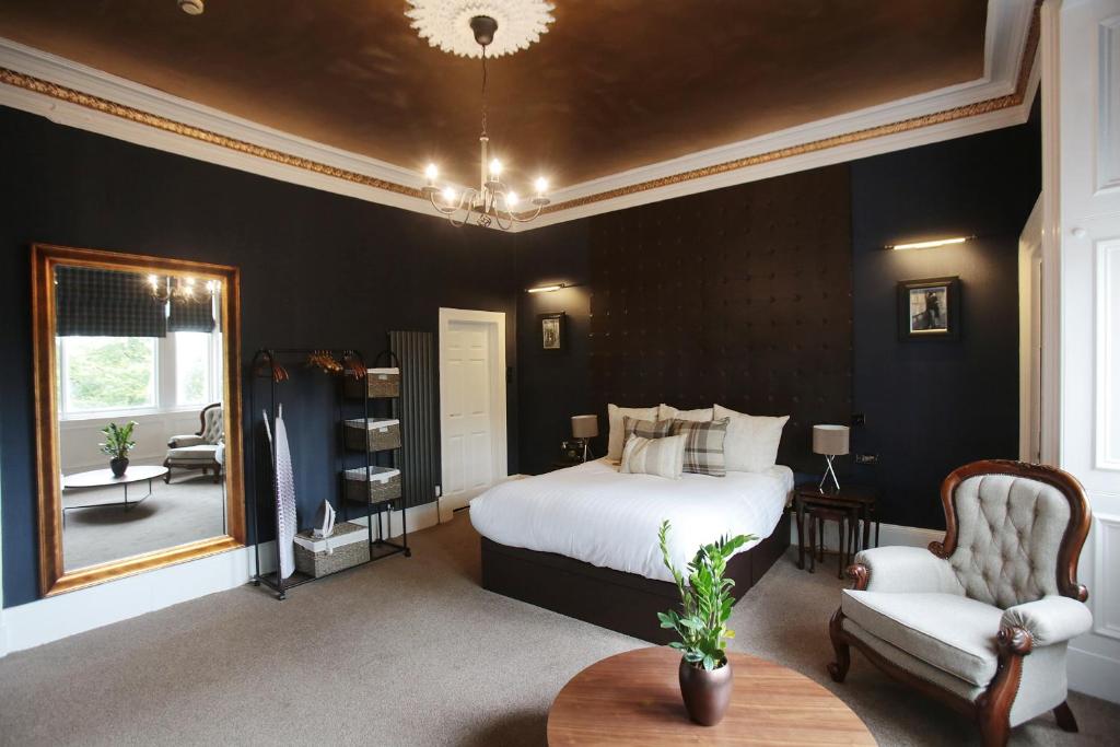 格拉斯哥贝尔哈文酒店的一间卧室配有一张床、一把椅子和镜子