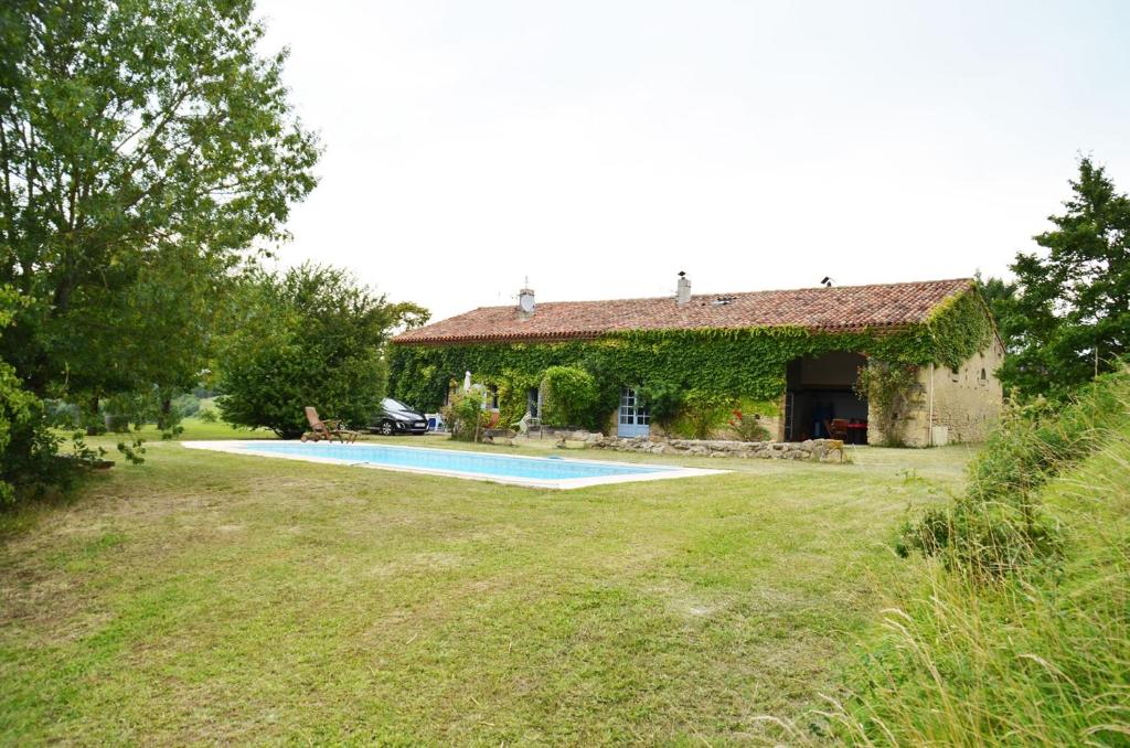 Auriac-sur-Vendinelle奥坦玫瑰度假屋的庭院中带游泳池的房子