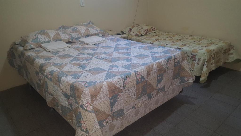 北茹阿泽鲁Pousada Portal do Cariri的一间卧室配有床,床上装有被子