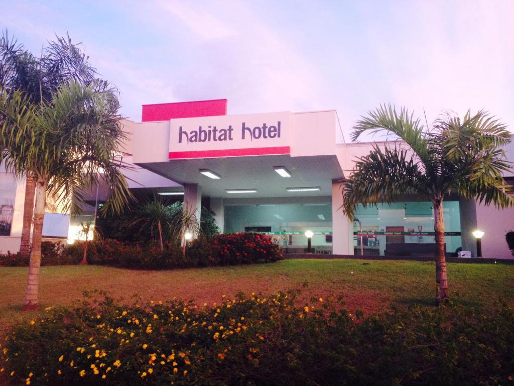 皮拉苏农加Habitat Hotel Pirassununga的一座楼前有棕榈树的酒店