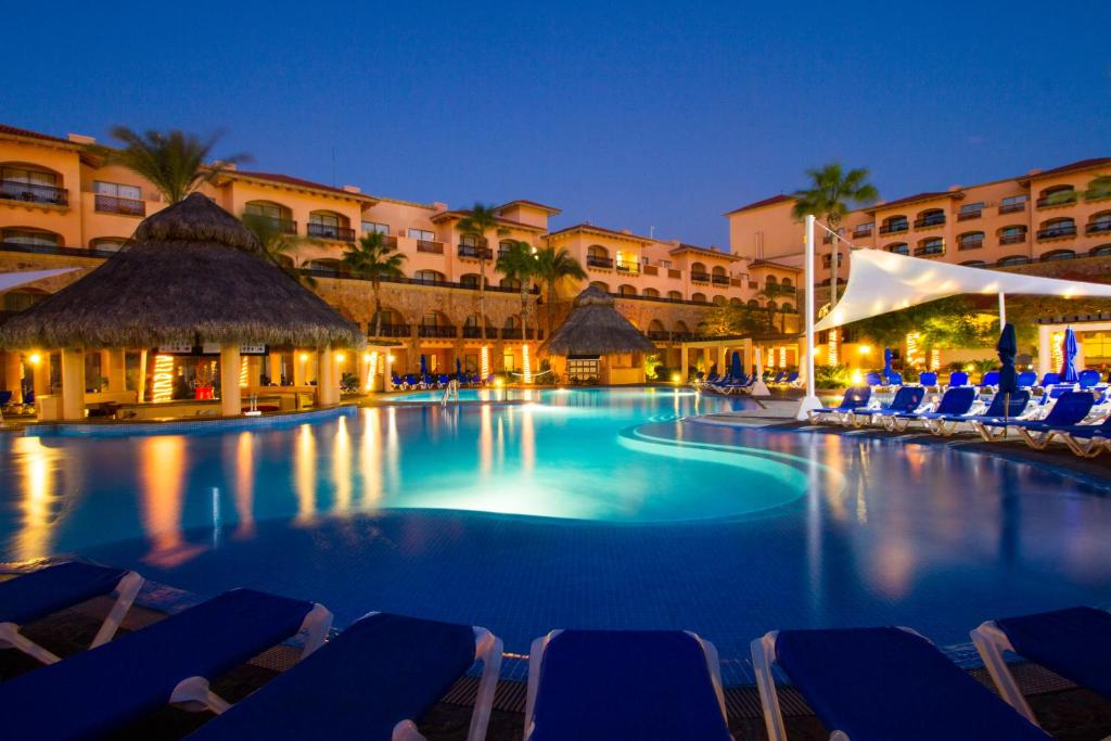 圣何塞德尔卡沃皇家索拉里斯洛斯卡沃斯酒店 - 全包的夜间游泳池,带椅子和建筑物