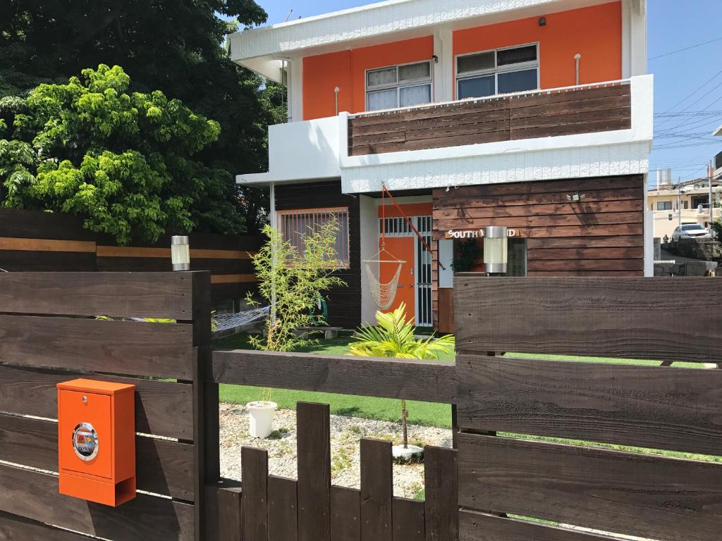 糸满南岛旅馆的围栏后面的一座房子,里面装有橙色邮箱