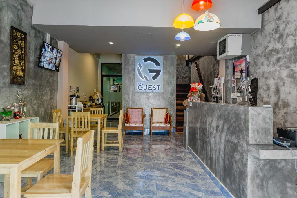 甲米镇The Guest Hotel Krabi的一间带桌椅的用餐室和一间餐厅