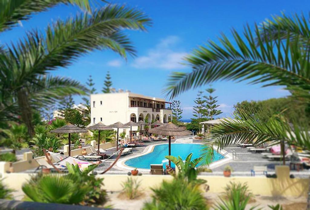 卡马利天域度假酒店的一个带游泳池和棕榈树的度假村