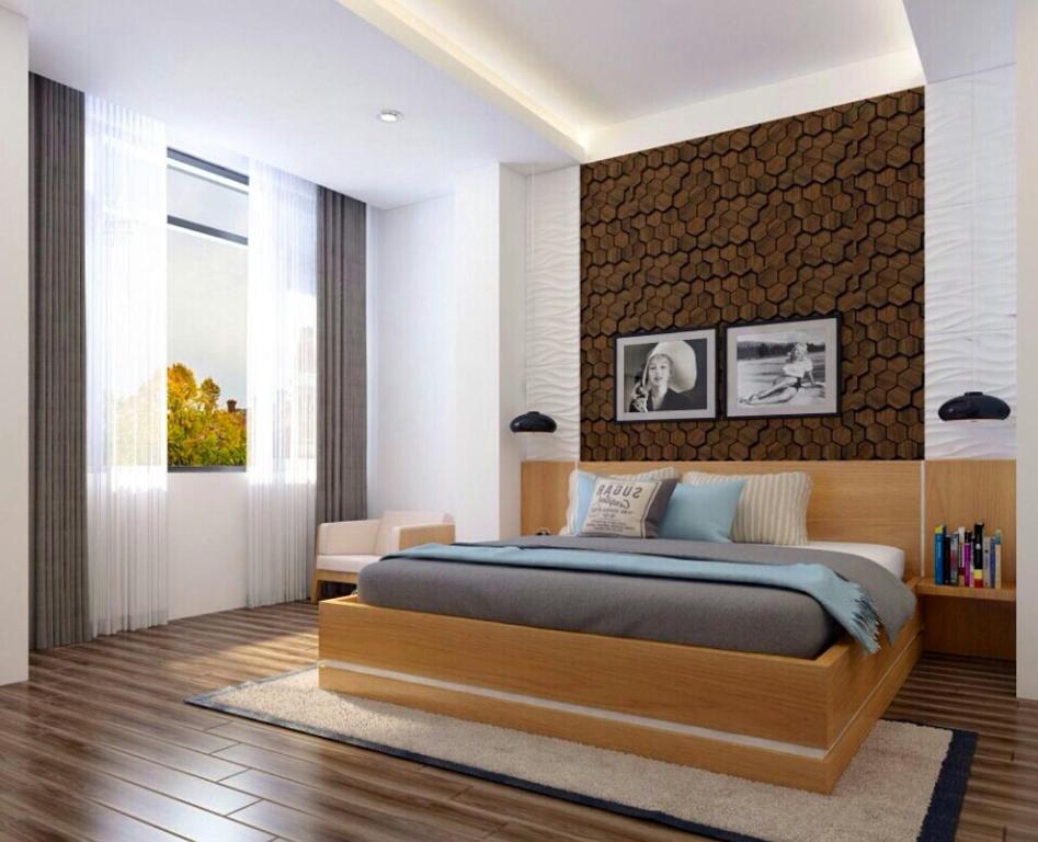 北宁恒波克酒店的一间卧室设有一张大床和砖墙