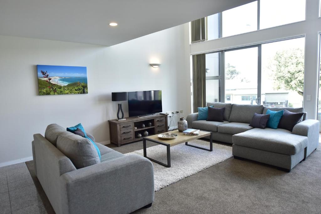 奥克兰埃普索姆公寓的客厅配有两张沙发和一台电视机