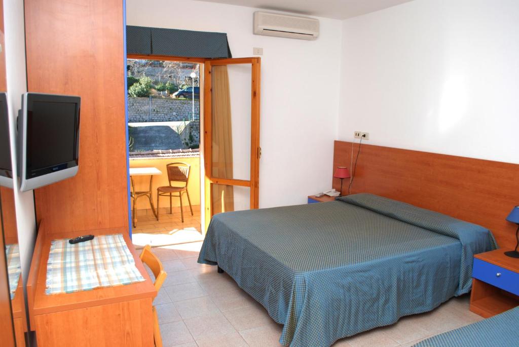 瑟克罗达凡酒店的一间卧室配有一张床、一台电视和一张桌子