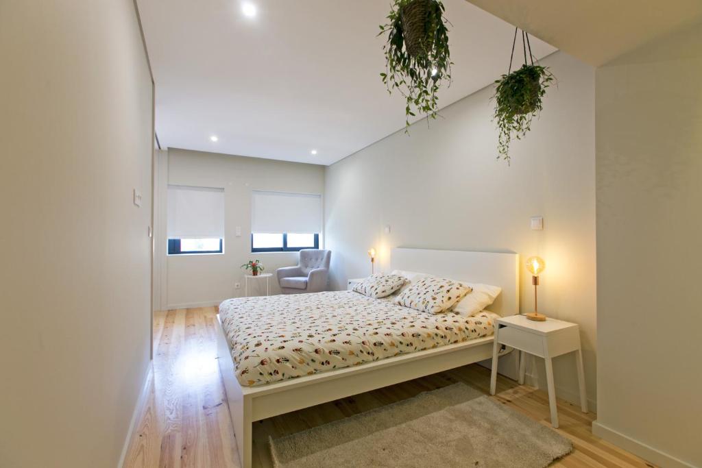 波尔图Porto Nascente的白色卧室配有床和椅子