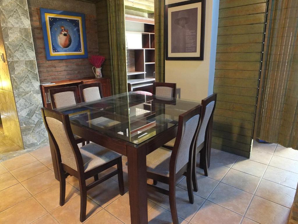 Rinconada de los AndesCasa Camelia的一间设有玻璃桌和椅子的用餐室