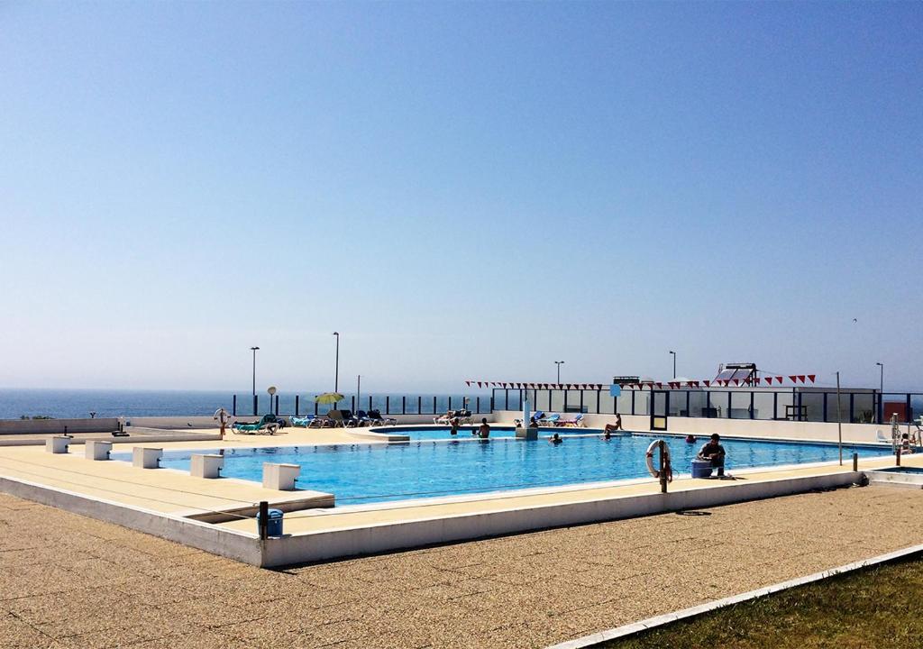加亚新城Parque de Campismo Orbitur Canidelo的毗邻大海的大型游泳池