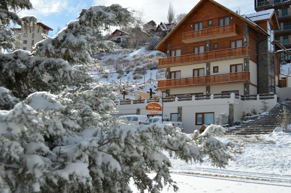 法洛伦斯瓦卢盖小屋酒店的前面有雪覆盖的树木的建筑