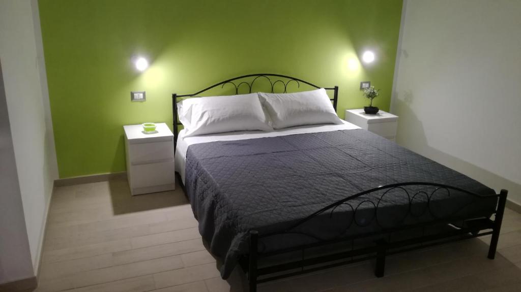 菲乌米奇诺盆景住宿加早餐旅馆的一间卧室设有一张带绿色墙壁的大床