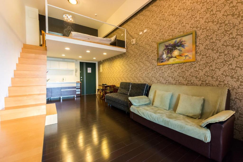礁溪宜兰礁溪L温泉行馆的带沙发和楼梯的客厅