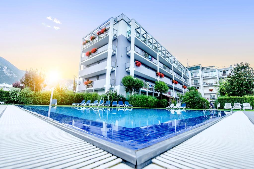 加尔达湖滨大使套房酒店的建筑前的一座带游泳池的建筑