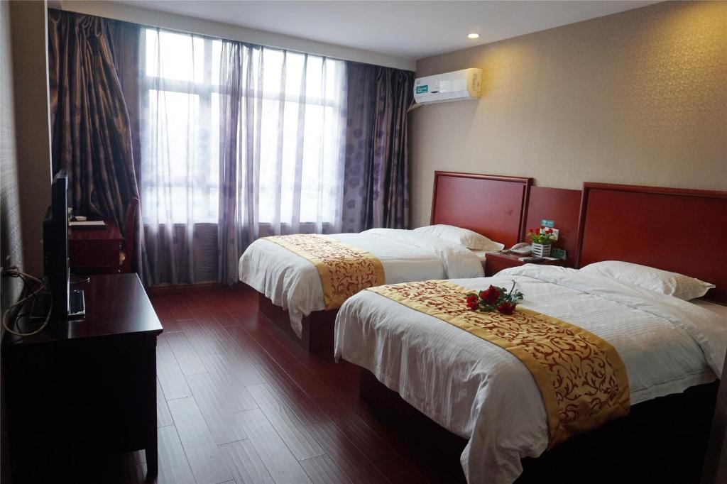 日照贝壳日照东港区长途汽车总站酒店的酒店客房设有两张床和窗户。