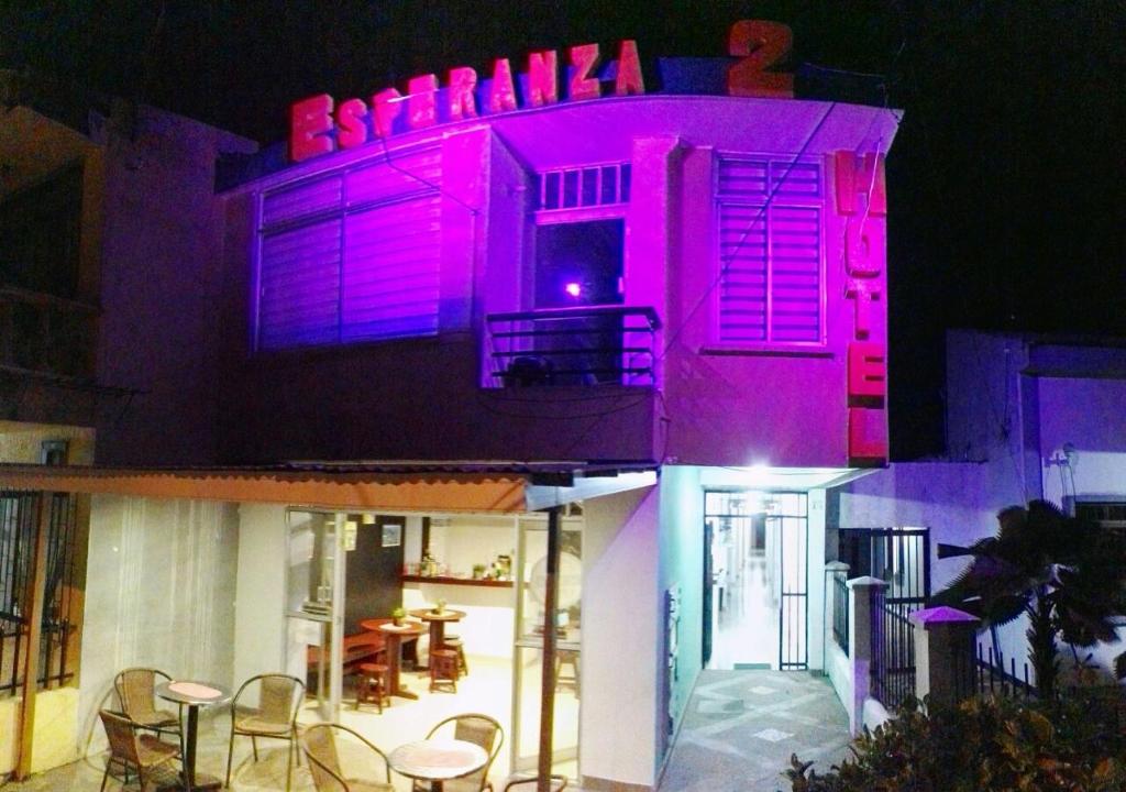 莱蒂西亚Hotel La Esperanza 2的上面有紫色灯的建筑