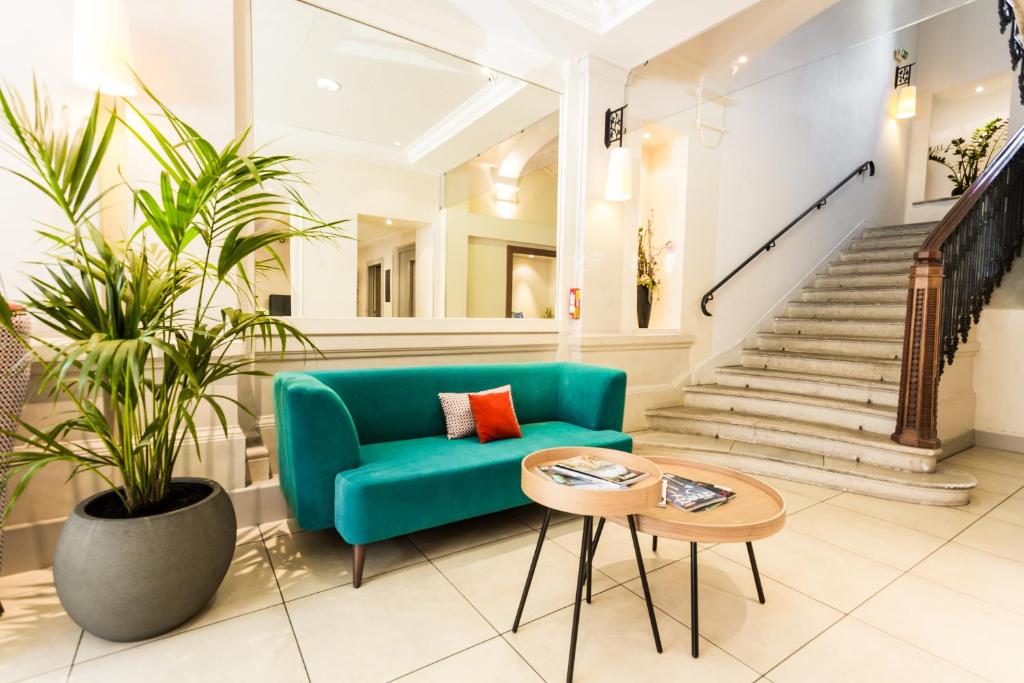 安锡Apparthotel Privilodges Le Royal的客厅配有绿色沙发和桌子