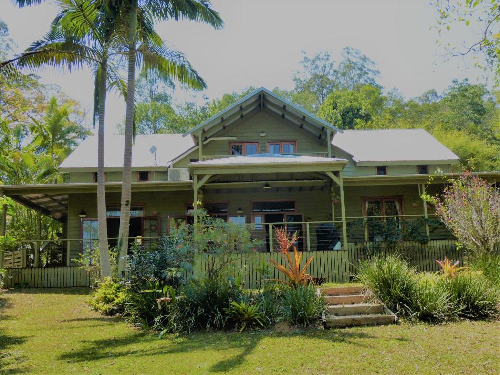 Cooroy木兰度假屋的前面有棕榈树的房子