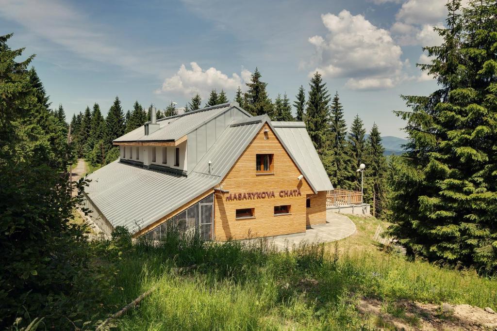 BumbalkaMasarykova Chata的森林中带金属屋顶的木屋