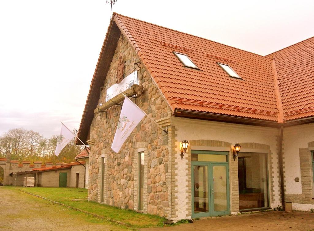 KurnaÜksik Rüütel Hotel的一座红色屋顶的石头建筑