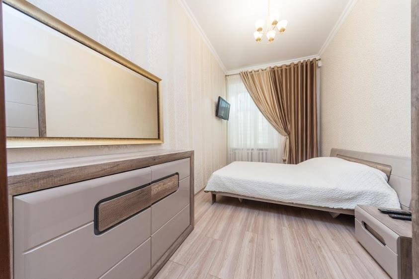 敖德萨center, Apartment on Deribasovskaya 10的一间卧室配有一张床和一面大镜子