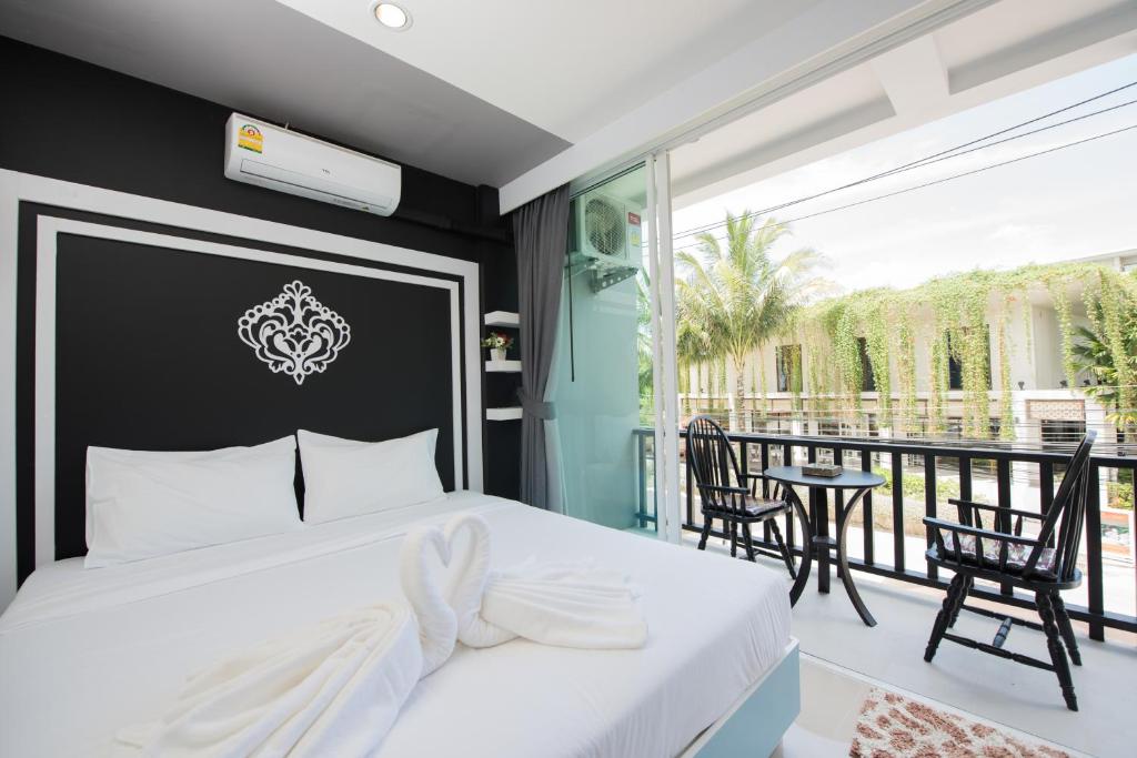 奈扬海滩Vacation Time House的一间带白色床的卧室和一个阳台