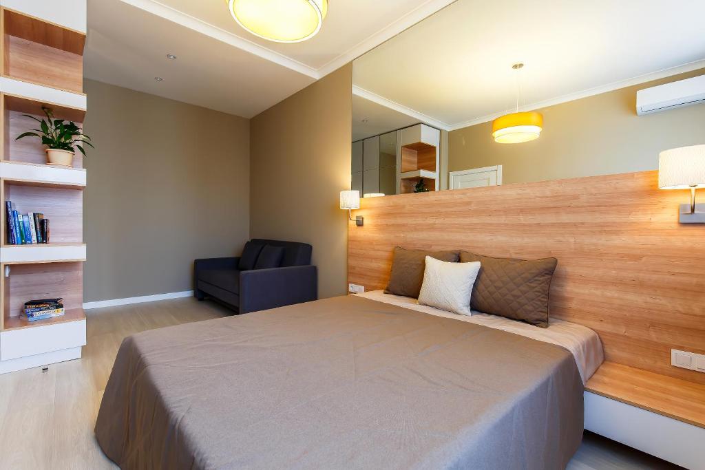 阿斯塔纳阿斯塔纳伊寇公寓酒店的一间卧室配有一张大床和一把椅子