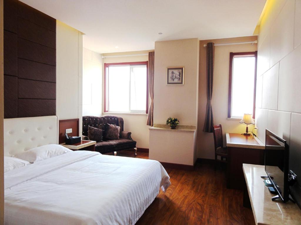 青岛青岛华奇凯帝酒店 的酒店客房设有一张大床和一张沙发。