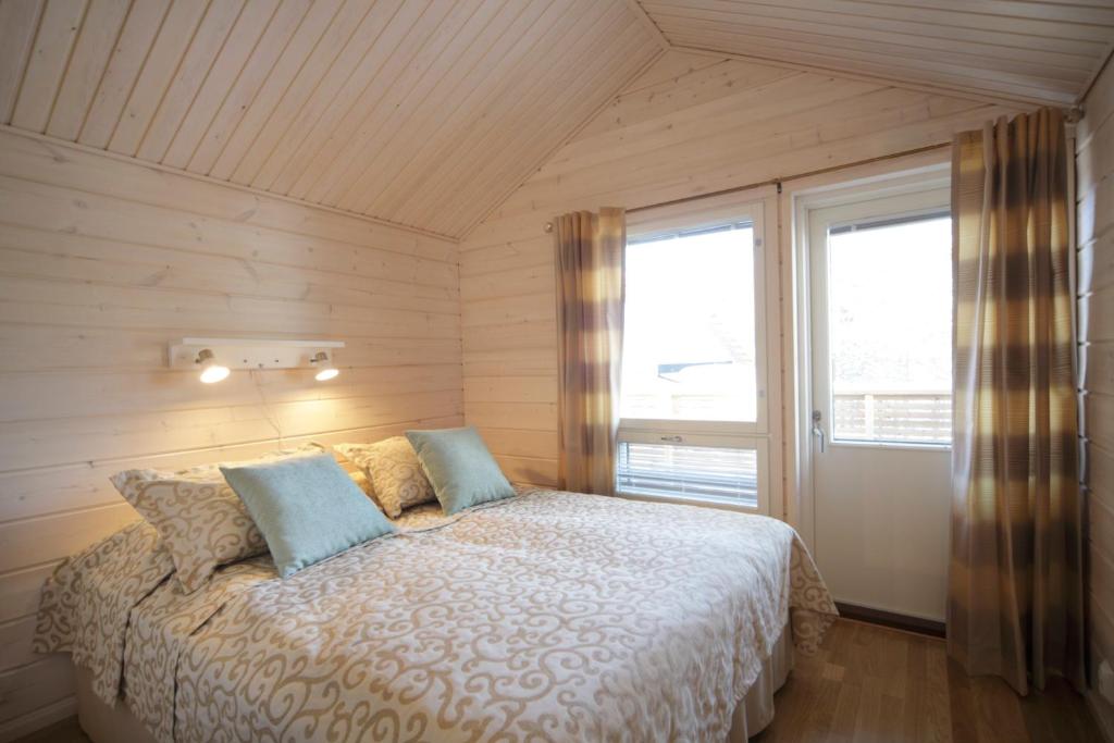 耶姆赛西莫斯假日俱乐部公寓的一间卧室配有带两个枕头的床和窗户